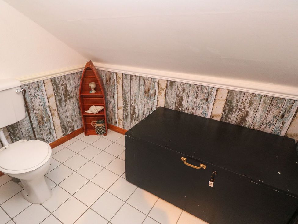 A bathroom with a toilet and a storage chest at Mill House Barn