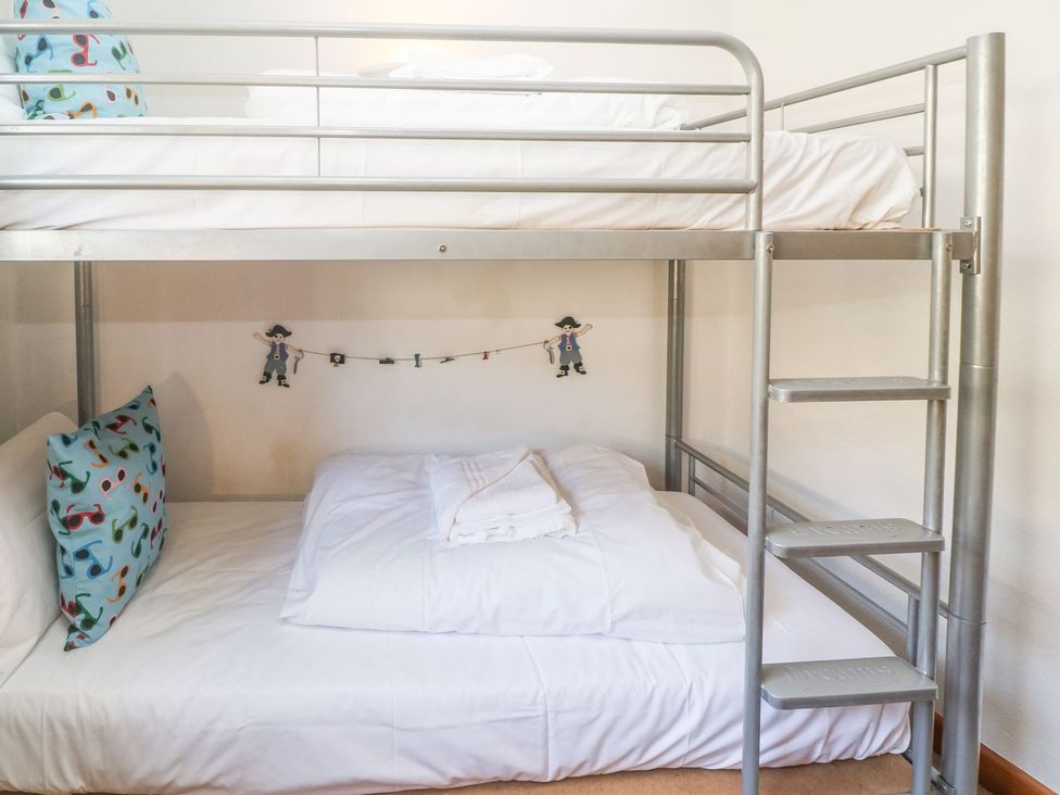 A bunk bed with pillows and sheets at Mill House Barn