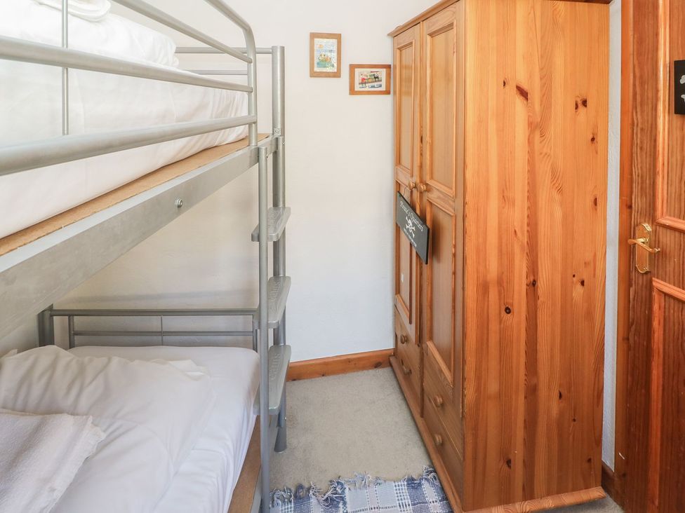A bunk bed and wardrobe in a bedroom at Mill House Barn
