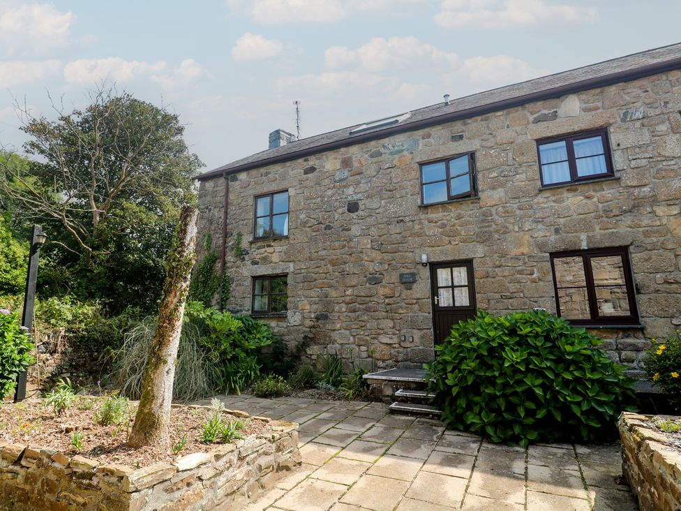 An exterior view of a stone house with a pathway and garden at Mill House Barn Gulval near Penzance