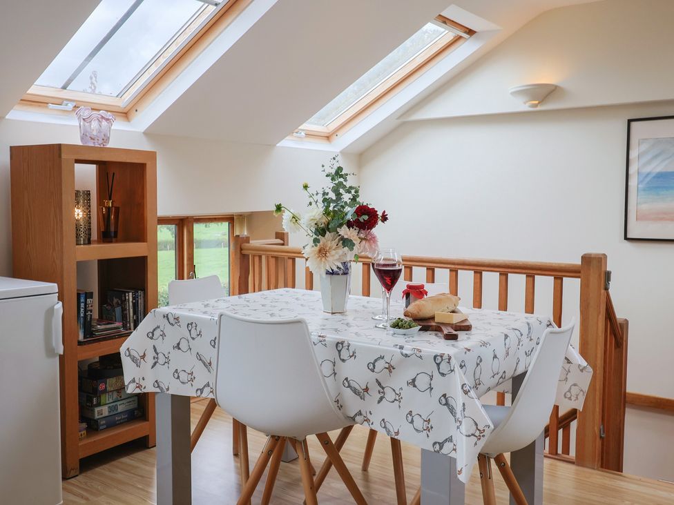 A dining room with a table and chairs at The Dairy in 