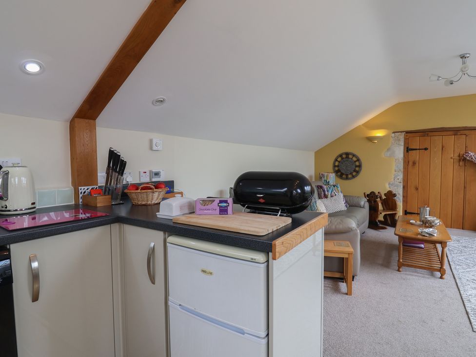 A kitchen with appliances and seating area at The Dairy 