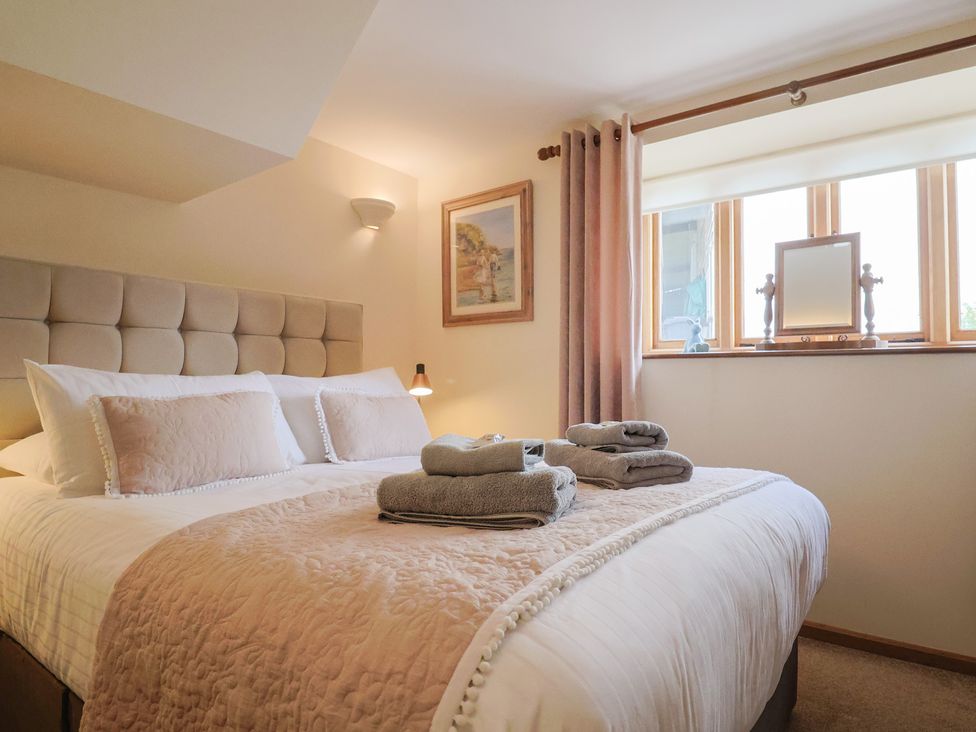 A bedroom with a bed and window at The Dairy 