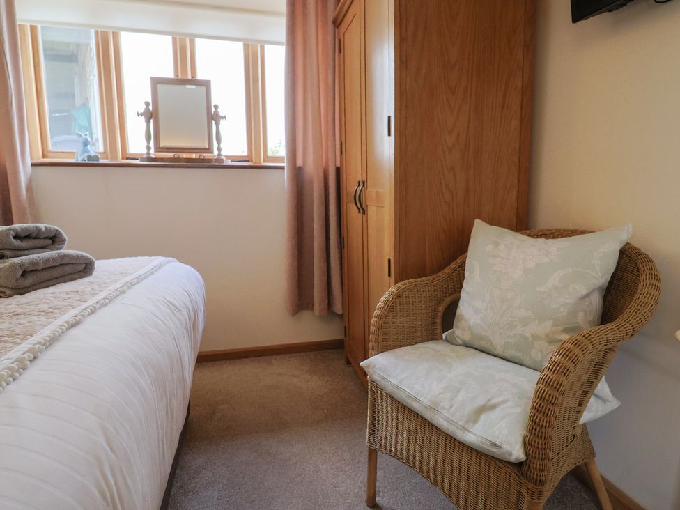 A bedroom with a bed and a chair at The Dairy in 