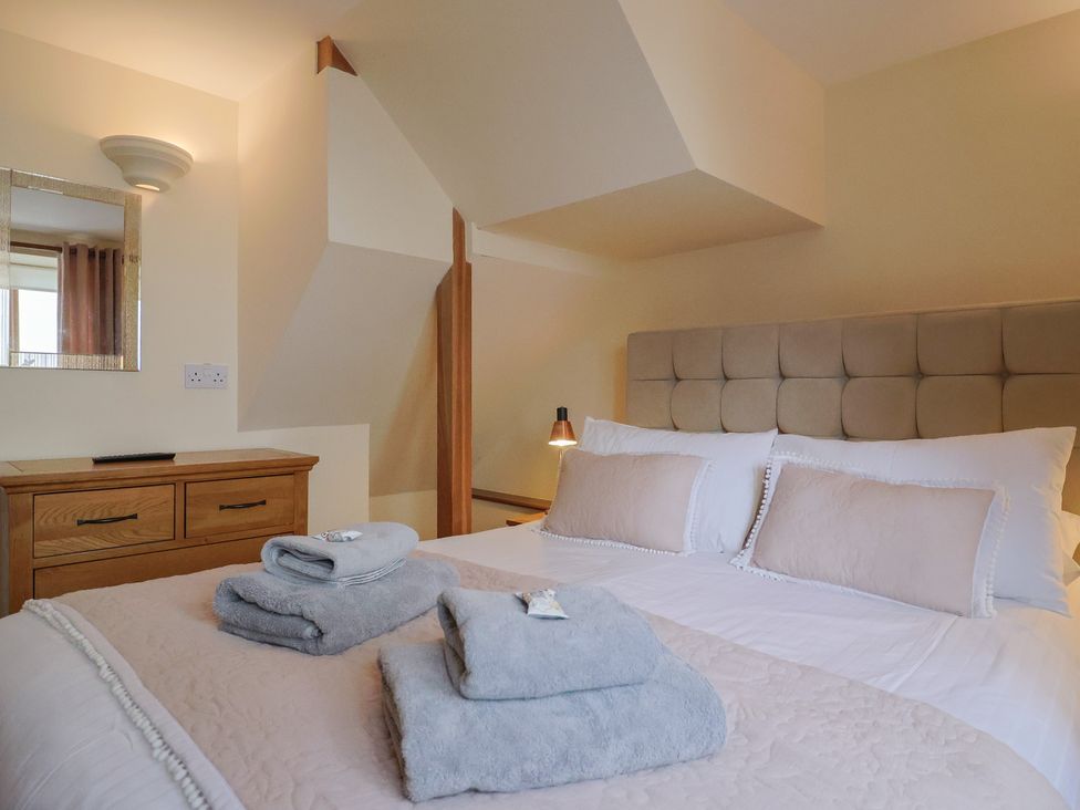 A bedroom with a double bed and a dresser at The Dairy in 