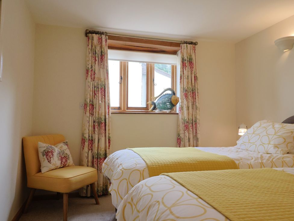 A bedroom with two beds and a window at The Dairy in 