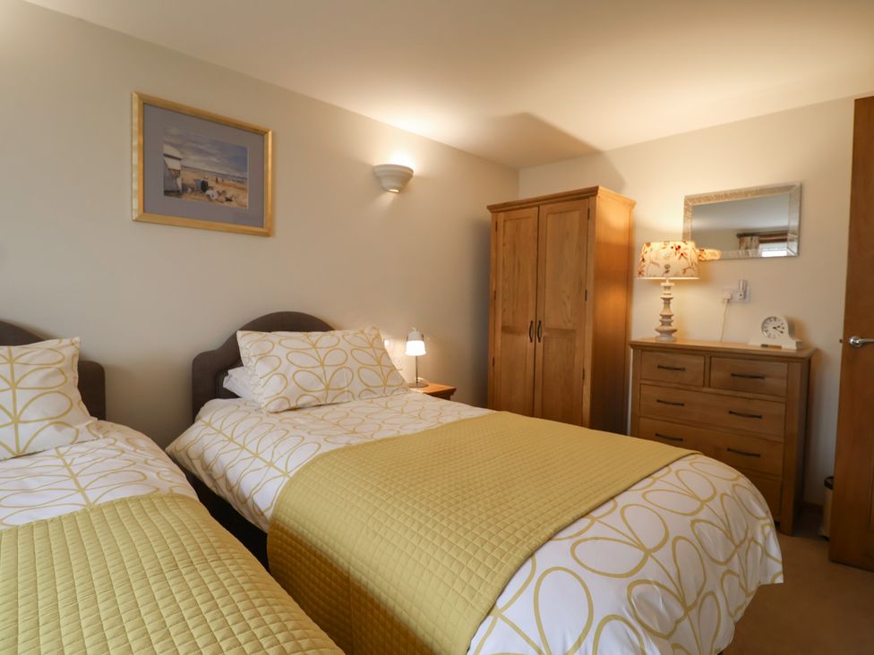 A bedroom with two beds and a dresser at The Dairy in 