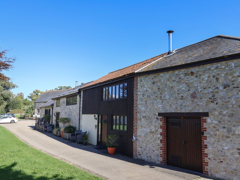 A house with stone wall and driveway at The Dairy in 