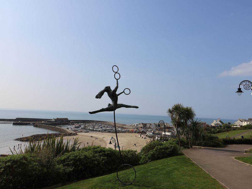 A view of a beach with a sculpture and boats at The Dairy in 