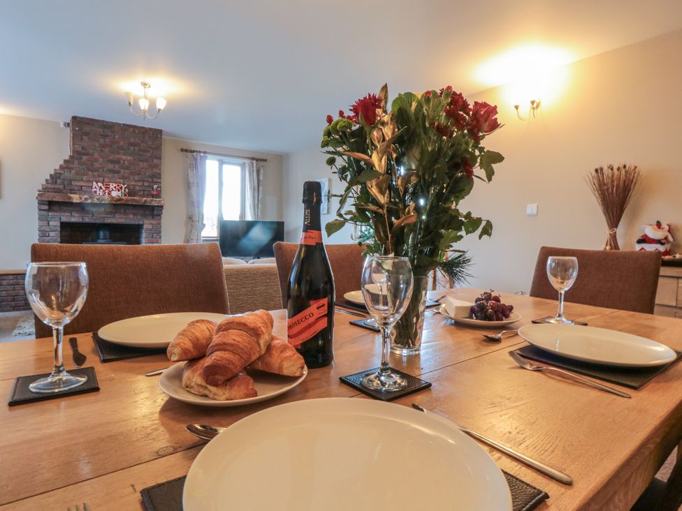 A dining room with a table set for a meal at Pasture View in Sneatonthorpe near Whitby
