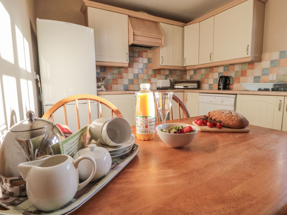 A kitchen with a dining table set for tea at Pasture View, Sneatonthorpe near Whitby