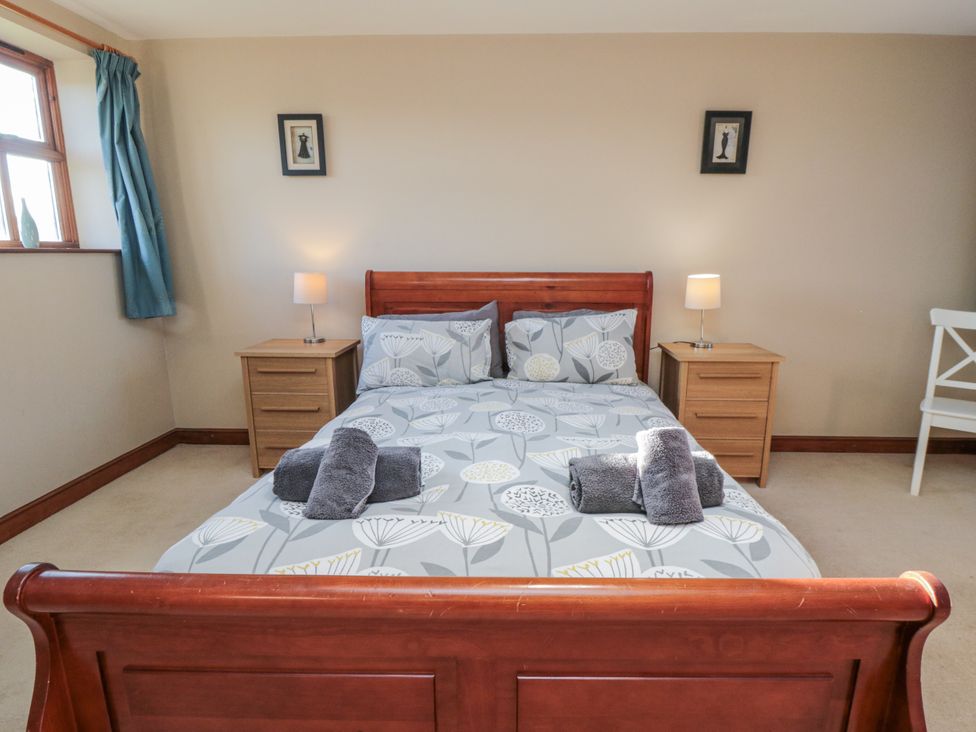 A bedroom with a bed and bedside tables at Pasture View in Sneatonthorpe near Whitby