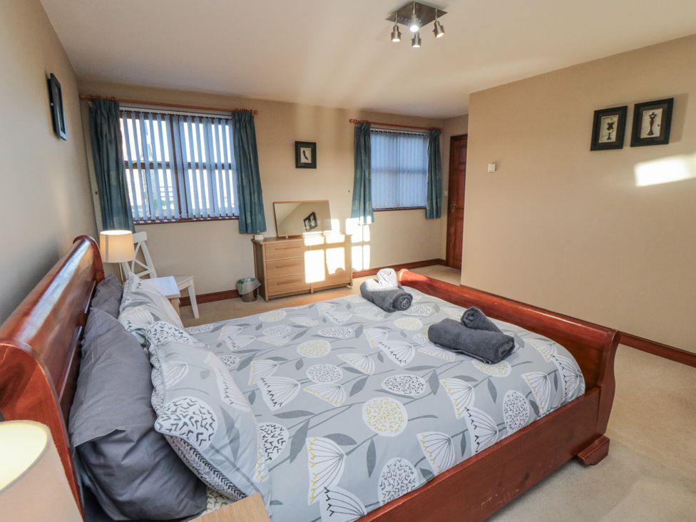 A bedroom with a bed and dresser at Pasture View Sneatonthorpe near Whitby