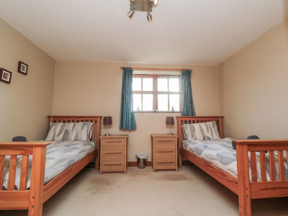 A bedroom with two beds and a window at Pasture View Sneatonthorpe near Whitby