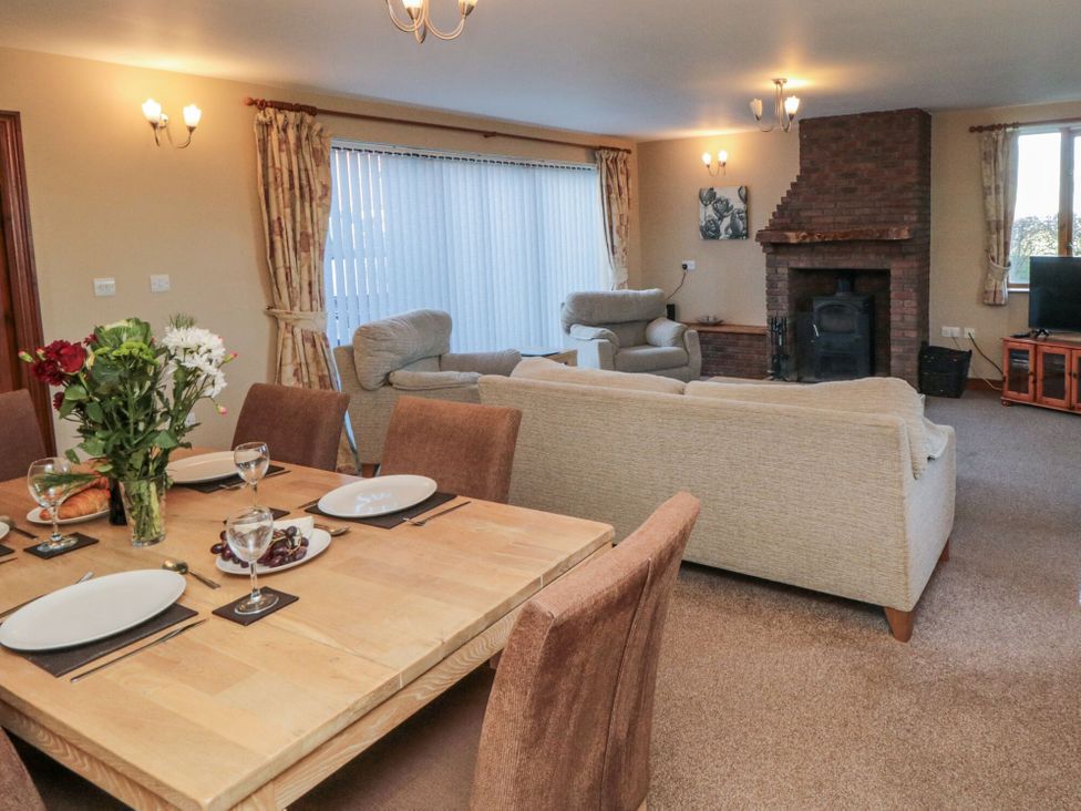 A dining room with a table and chairs and a seating area at Pasture View Sneatonthorpe near Whitby