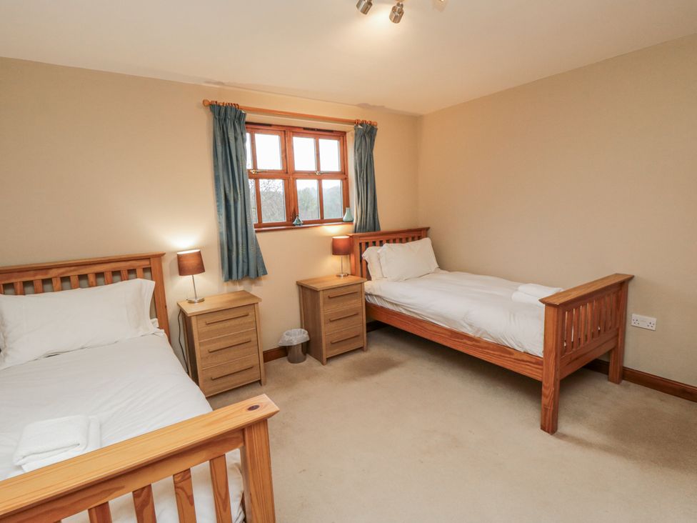 A bedroom with two beds and a window at Pasture View Sneatonthorpe near Whitby