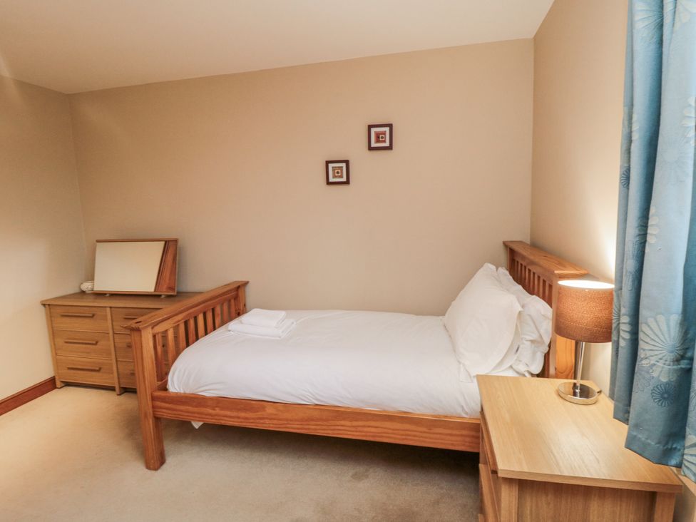 A bedroom with a single bed and a dresser at Pasture View Sneatonthorpe near Whitby