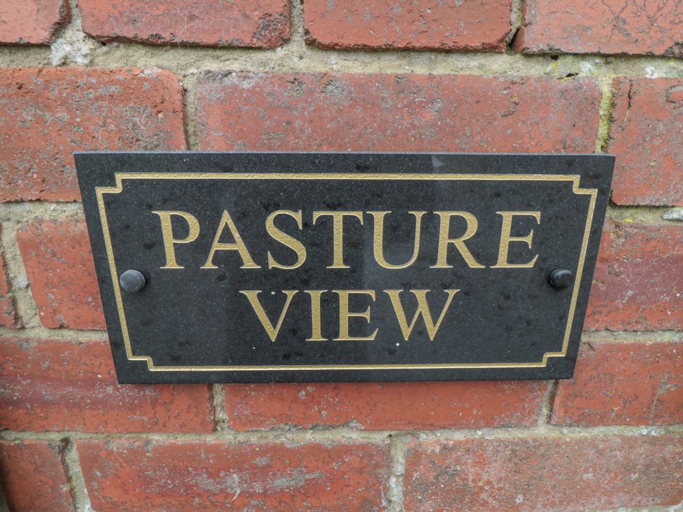 A sign that says Pasture View on a brick wall at Pasture View Sneatonthorpe near Whitby