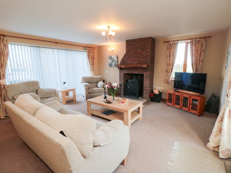 A living room with furniture including a sofa and television at Pasture View Sneatonthorpe near Whitby