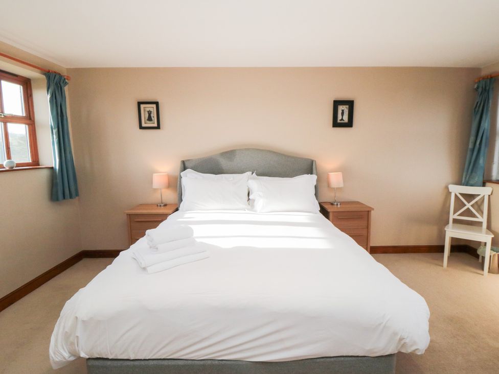 A bedroom with a bed and bedside tables at Pasture View in Sneatonthorpe near Whitby