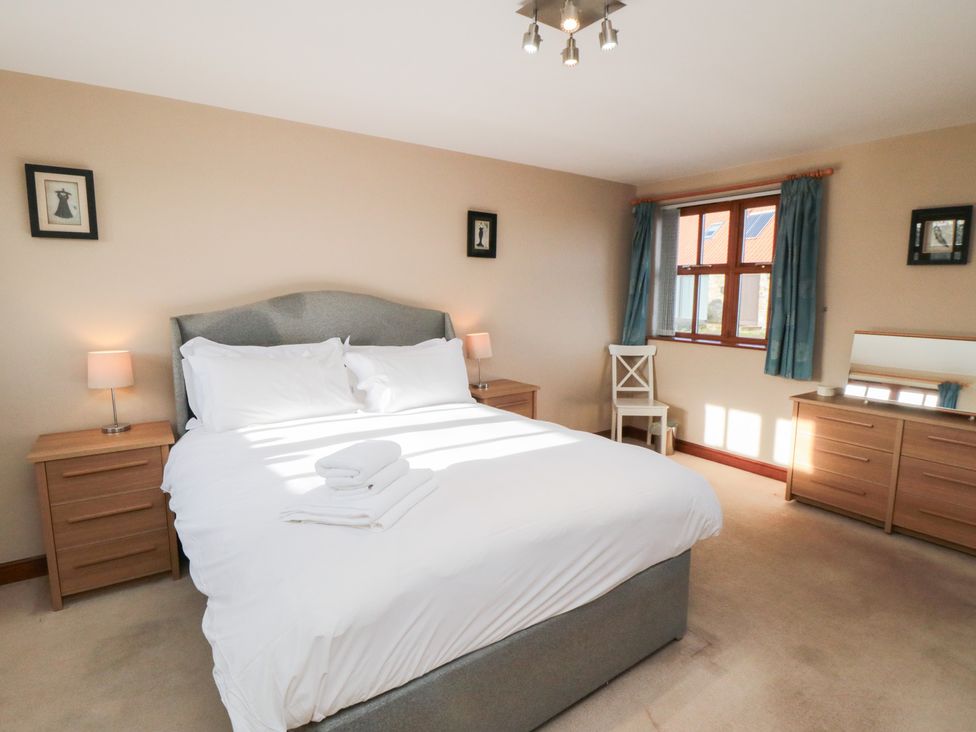 A bedroom with a bed and bedside tables at Pasture View Sneatonthorpe near Whitby