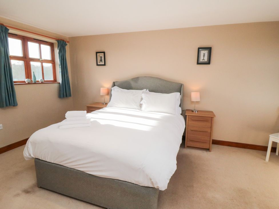 A bedroom with a double bed and nightstands at Pasture View in Sneatonthorpe near Whitby