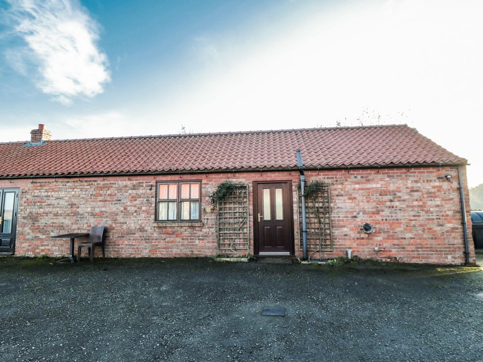 A brick exterior with a door and windows at Beck View