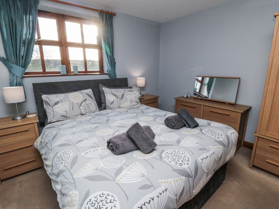 A bedroom with a bed and furniture at Beck View in Whitby