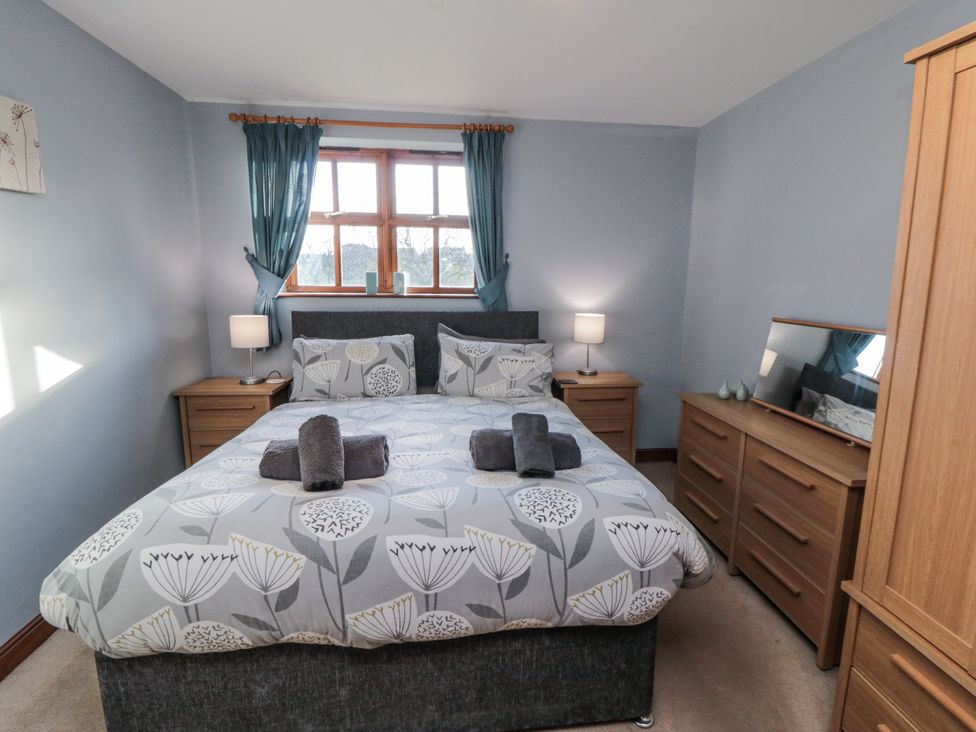 A bedroom with a bed and furniture at Beck View in Whitby