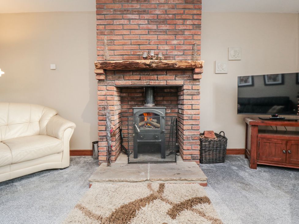 A living room with a fireplace and sofa at Beck View in Whitby