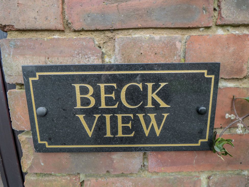 A nameplate on a brick wall at Beck View in Whitby