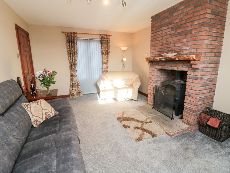 A living room with a fireplace and sofas at Beck View in Whitby
