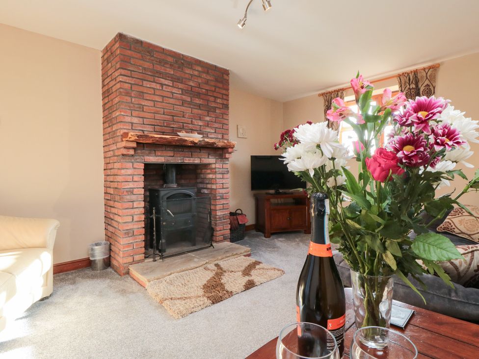 A living room with a fireplace and coffee table at Beck View in Whitby