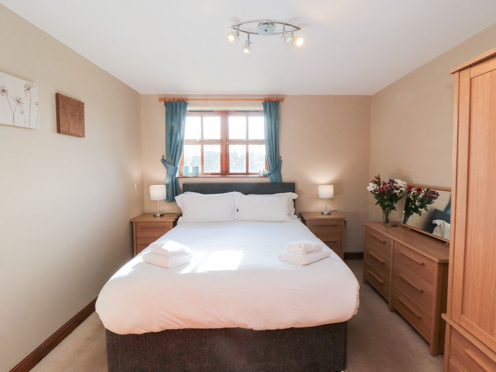 A bedroom with a bed and furniture at Beck View in Whitby