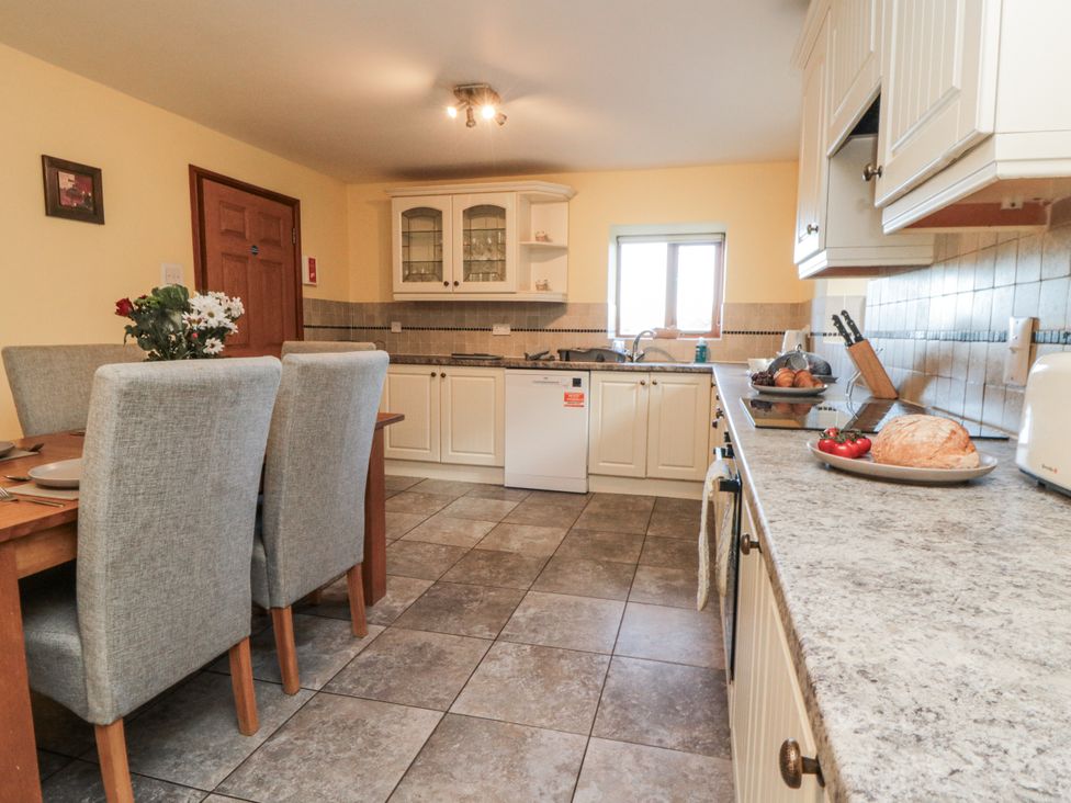 A kitchen with a table and chairs at Wheelhouse Cottage Sneatonthorpe near Whitby