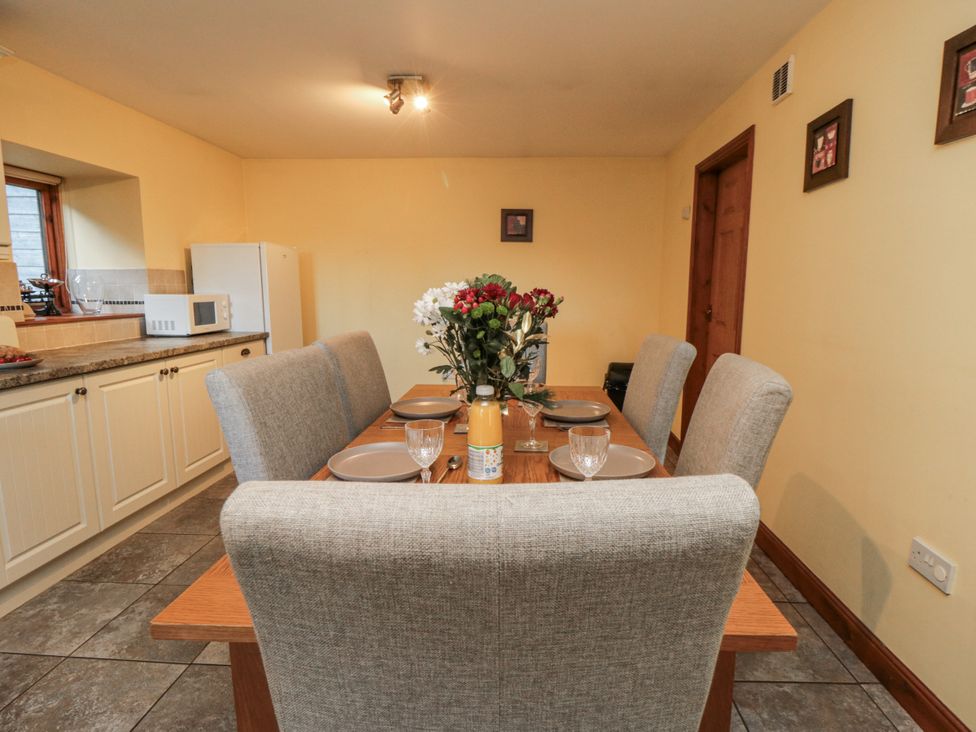 A dining room with a table and chairs at Wheelhouse Cottage in Sneatonthorpe near Whitby