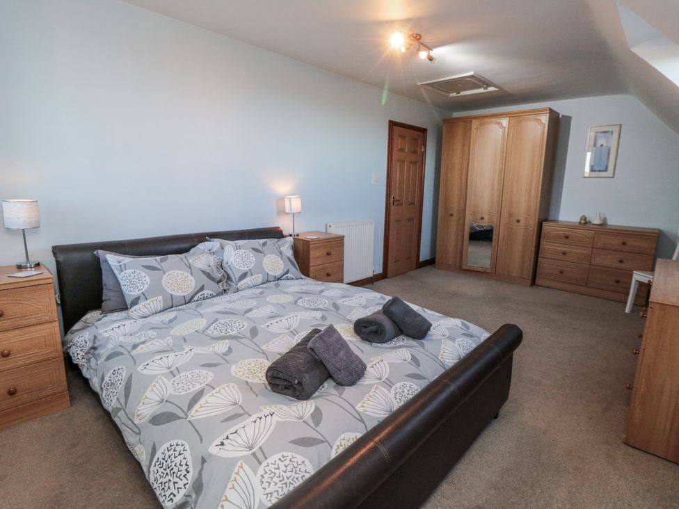 A bedroom with a bed and furniture at Wheelhouse Cottage Sneatonthorpe near Whitby