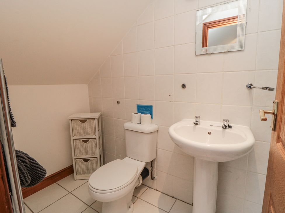 A bathroom with a toilet and wash basin at Wheelhouse Cottage Sneatonthorpe near Whitby