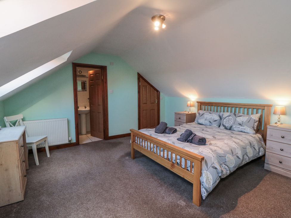 A bedroom with a bed and furniture at Wheelhouse Cottage Sneatonthorpe near Whitby
