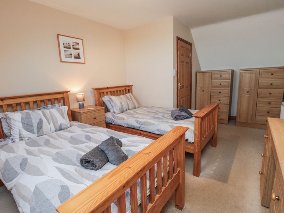 A bedroom with two single beds and a chest of drawers at Wheelhouse Cottage Sneatonthorpe near Whitby