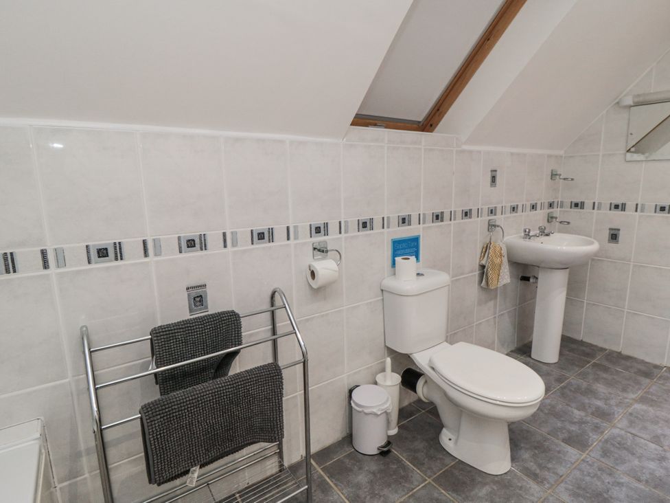 A bathroom with a sink and toilet at Wheelhouse Cottage in Sneatonthorpe near Whitby