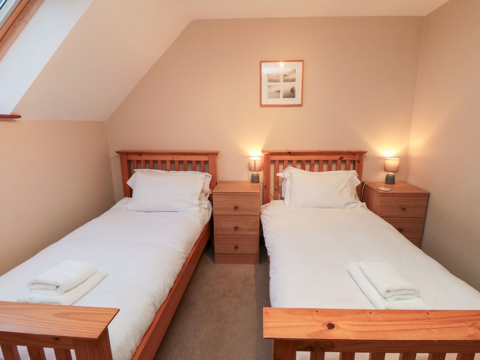 A bedroom with two single beds and bedside tables at Wheelhouse Cottage Sneatonthorpe near Whitby