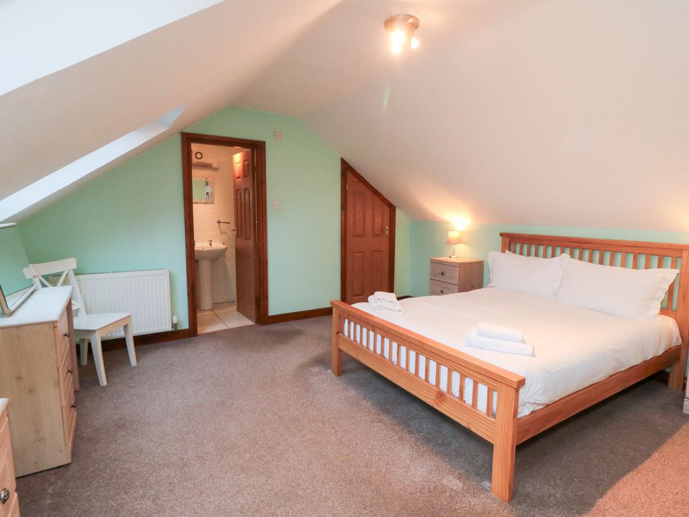 A bedroom with a bed and bedside table at Wheelhouse Cottage Sneatonthorpe near Whitby