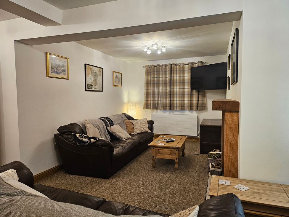 A living room with furniture and a television at Rockhurst Farm in Matlock