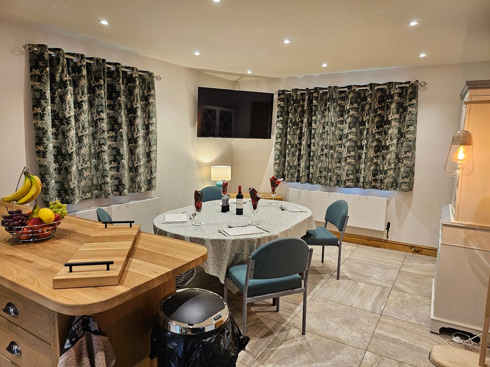 A dining room with a table and fruit at Rockhurst Farm Matlock