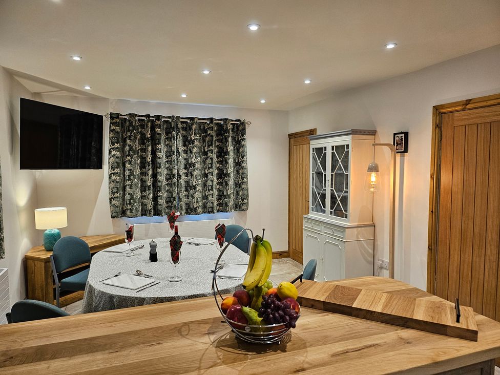 A dining room with a table and chairs at Rockhurst Farm in Matlock