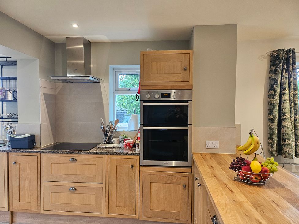 A kitchen with cabinets stove and oven at Rockhurst Farm in Matlock