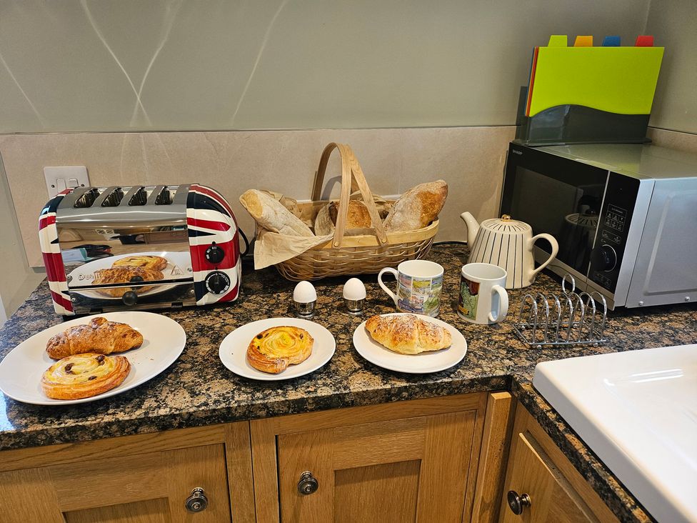 A kitchen with a toaster and pastries on a counter at Rockhurst Farm in Matlock