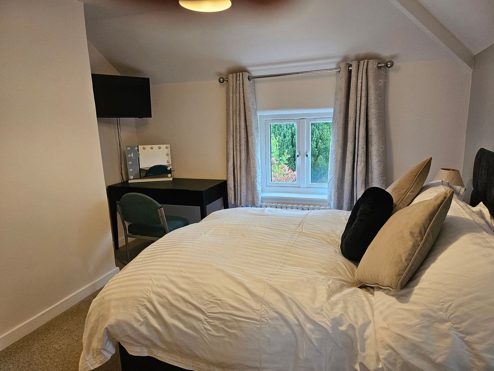 A bedroom with a bed and desk at Rockhurst Farm in Matlock
