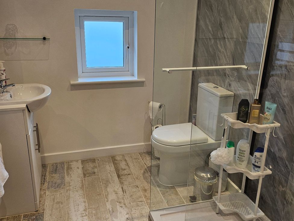 A bathroom with a sink, toilet and shower at Rockhurst Farm in Matlock